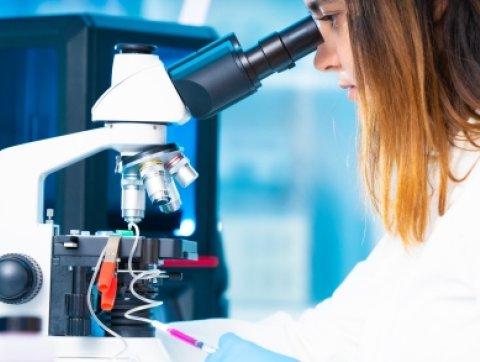 technician girl with microfluidic device LOC in microbiologi